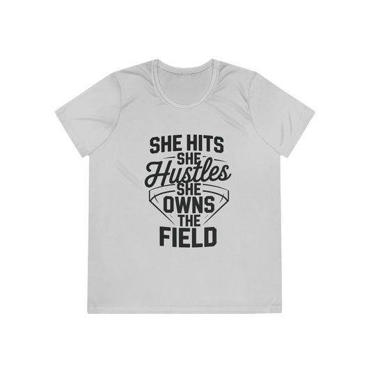 She Hits She Hustles She Owns the Field Ladies Moisture Wicking Tee
